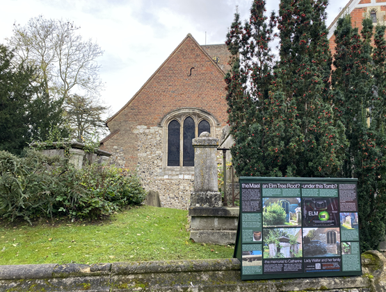 A brick building with a sign in front of itDescription automatically generated with medium confidence